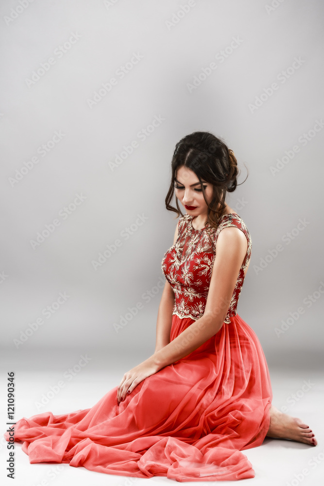 Portrait of a beautiful young woman in red dress. Portrait of a beautiful young woman in red dress.