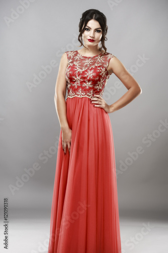 Portrait of a beautiful young woman in red dress.