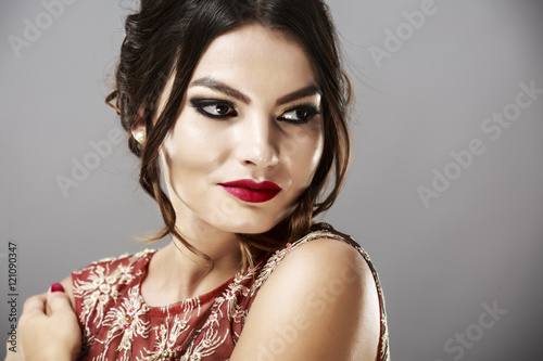 Portrait of a beautiful young woman in red dress.