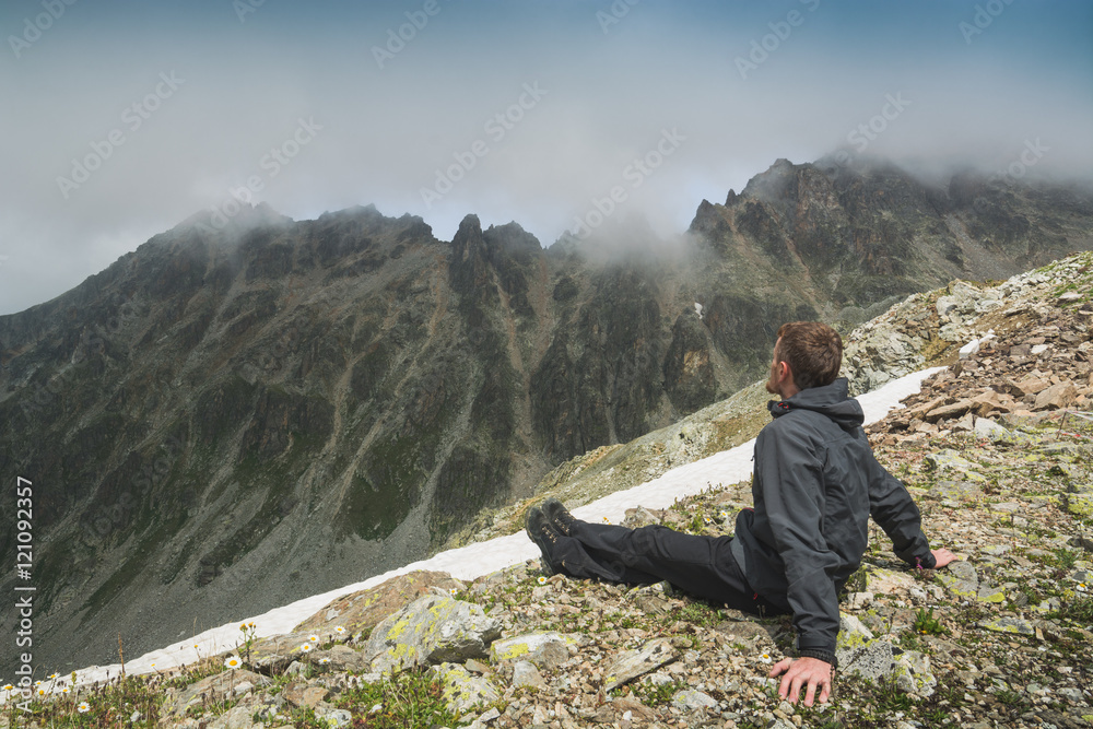 Hiker relaxing on top of a mountain
