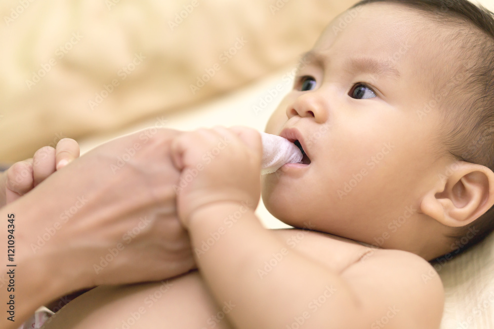 Mother cleans baby mouth