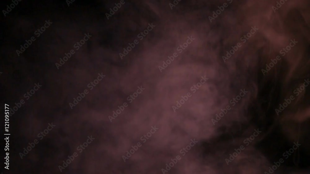 Fumo reale rosso prodotto da macchina del fumo con sfondo nero. Slow Motion. 