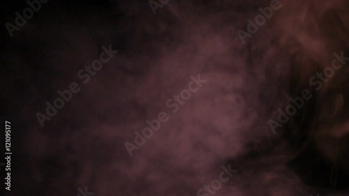 Fumo reale rosso prodotto da macchina del fumo con sfondo nero. Slow Motion.  photo