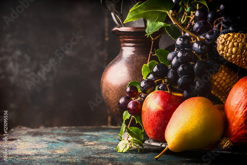 Fototapeta Naklejka Na Ścianę i Meble -  Autumn harvest concept. Fall fruits and vegetables on dark rustic kitchen table at wooden background, side view,copy space, close up