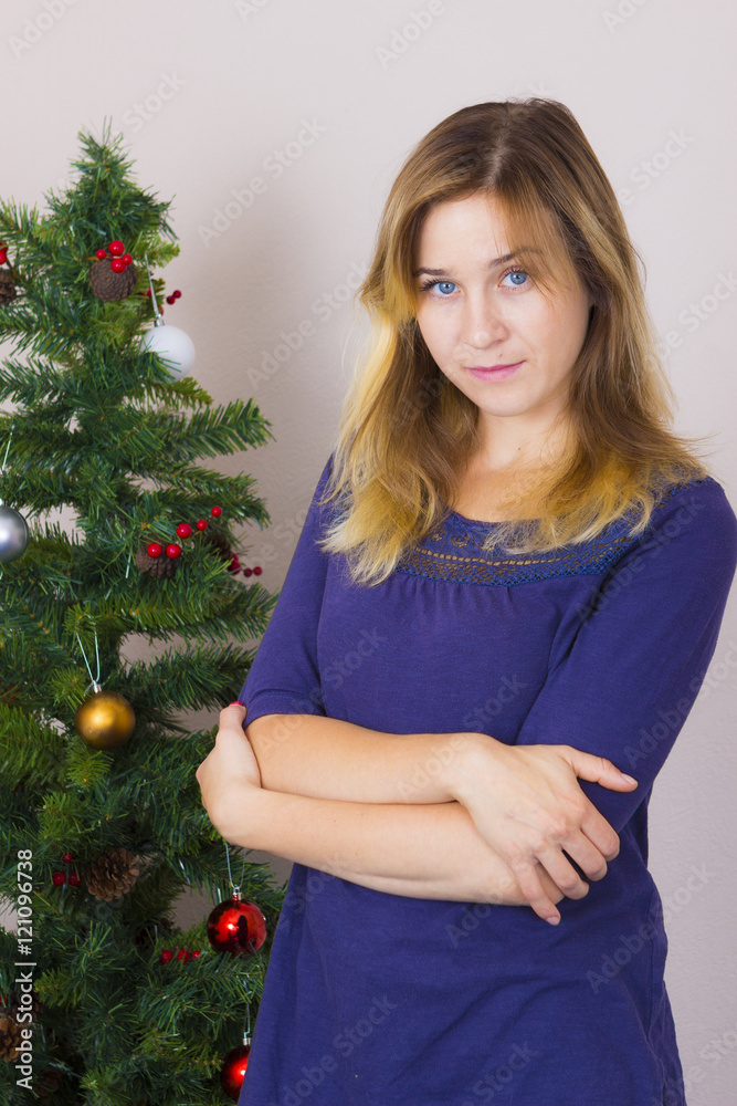 Young woman near New Year tree