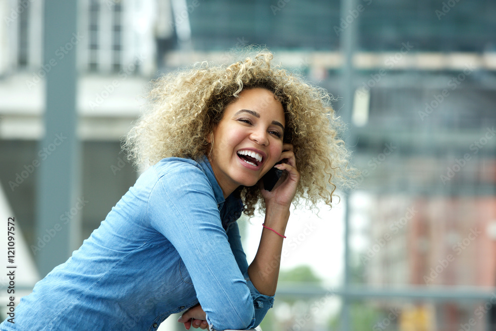 Attractive young woman laughing on telephone call Attractive young woman laughing on telephone call