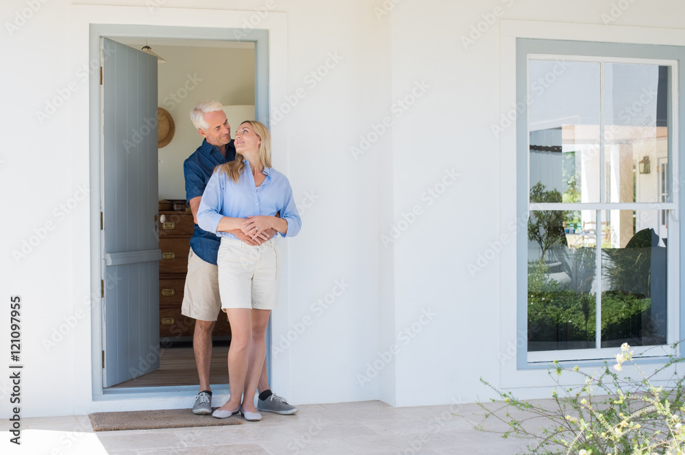 Couple hugging at door