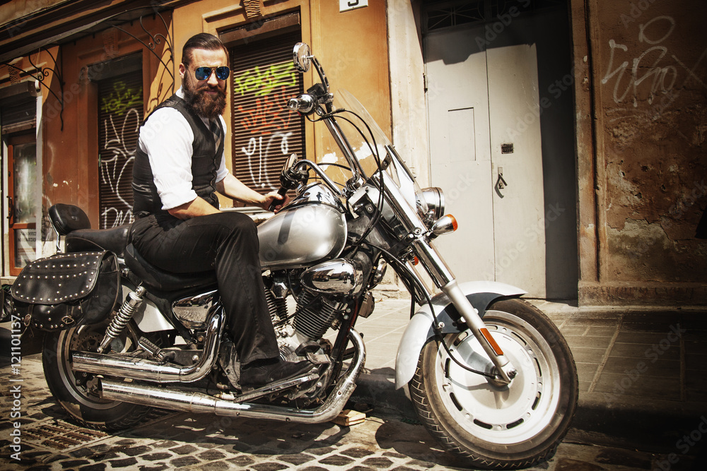 Serious Bearded Biker Man Sitting on a Motorcycle