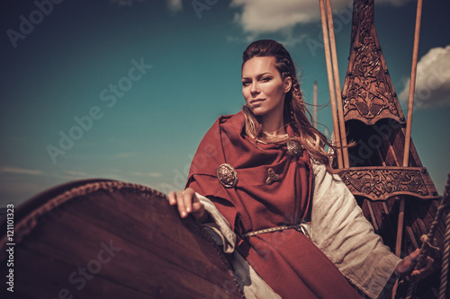 Viking woman with shield on Drakkar. photo