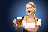Young sexy Oktoberfest waitress, wearing a traditional Bavarian dress, serving big beer mugs on blue background.