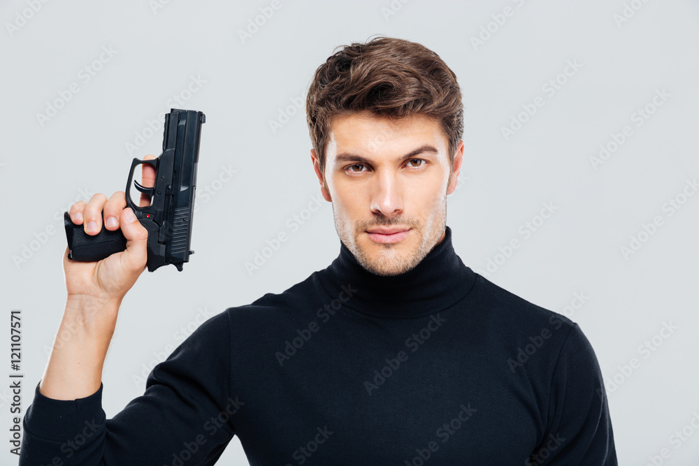 Portrait of handsome young man holding a gun Portrait of handsome young man holding a gun