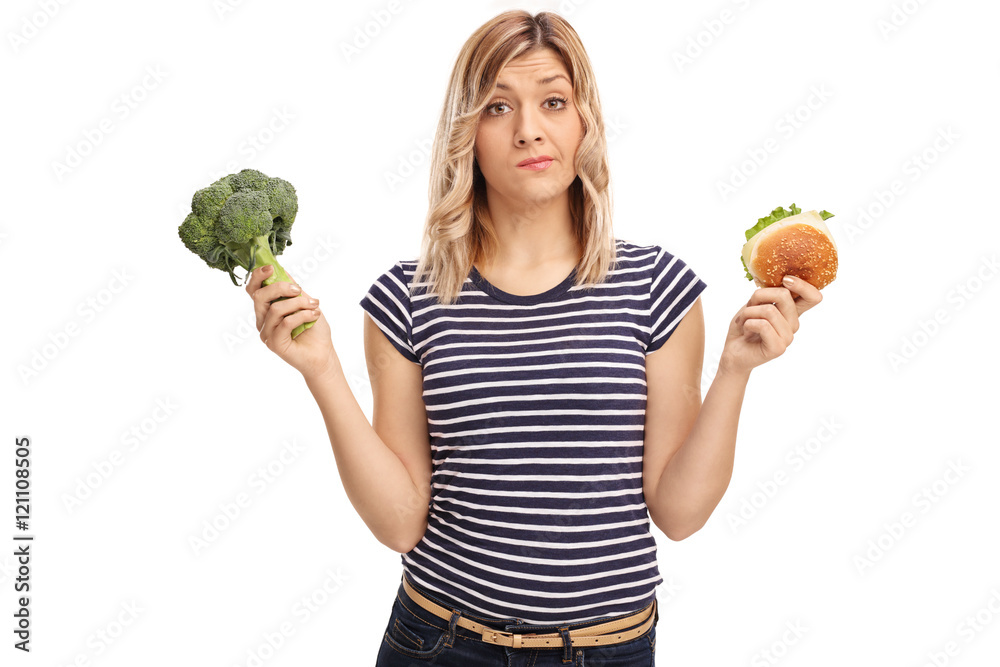Woman holding a sandwich and broccoli Woman holding a sandwich and broccoli
