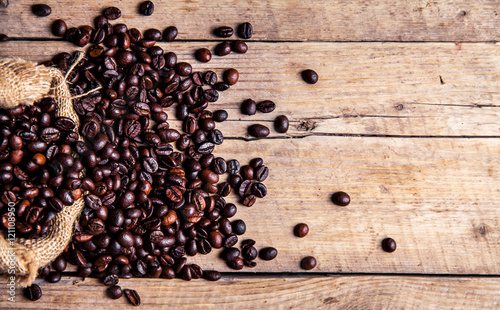 Coffee beans on the wooden background. Hot drinks.