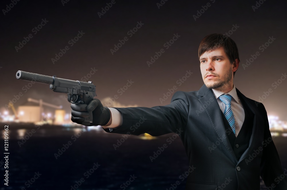 Secret agent or spy is aiming with pistol at night. Secret agent or spy is aiming with pistol at night.