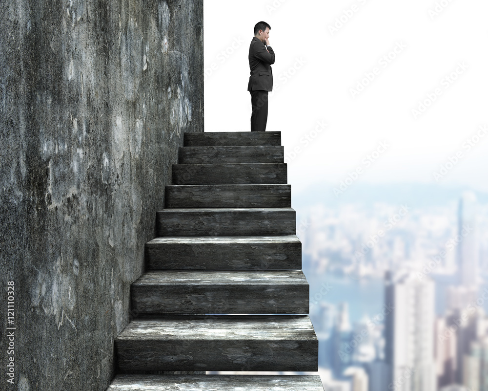Side view of man standing on top of concrete stairs