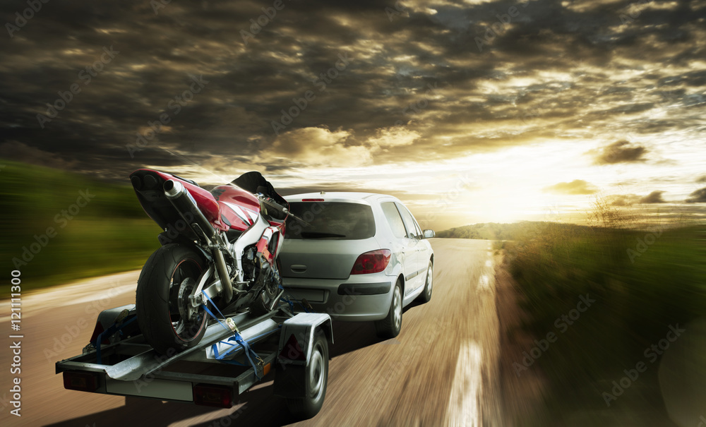 Obraz premium Race Motorbike On Trailer Behind Car
