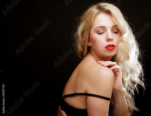 blond woman with  curly hair in black lingerie