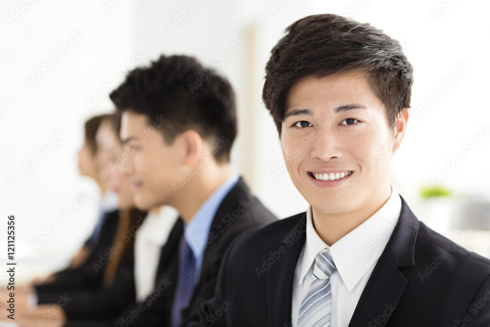 Smiling businessman looking at camera with his colleague Smiling businessman looking at camera with his colleague