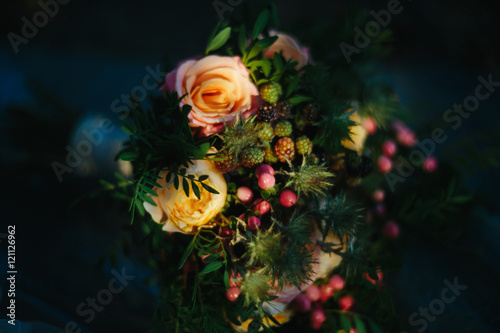 Forest berries put in a dark bouquet of roses