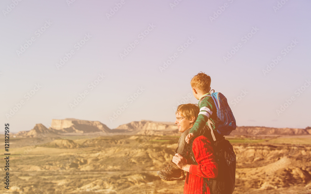 father and little son travel in mountains