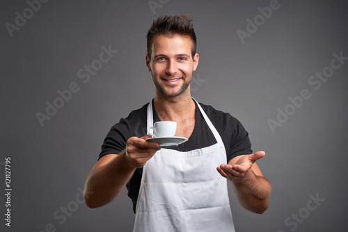 Obraz na płótnie A young barista man 