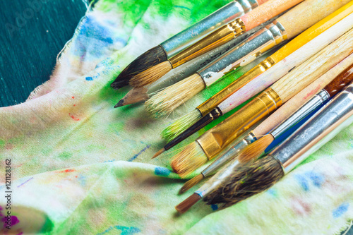 Paint brushes on wooden background