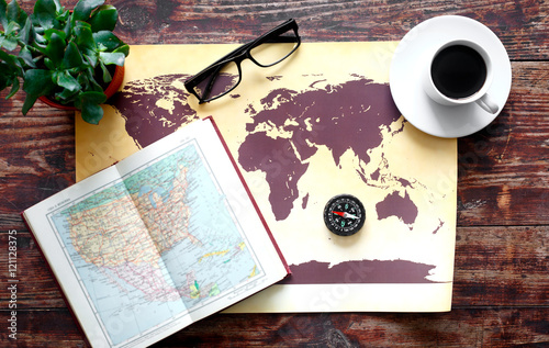 world map with coffee on wooden table top view