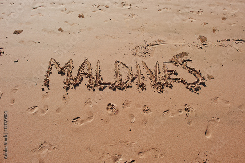 "Maldives" written in the sand on the beach