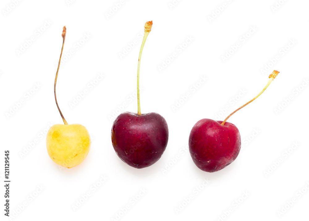 red and yellow cherries on white background