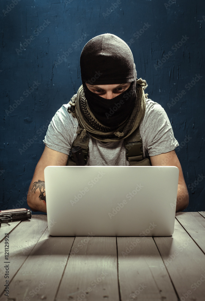 Terrorist working on his computer Terrorist working on his computer