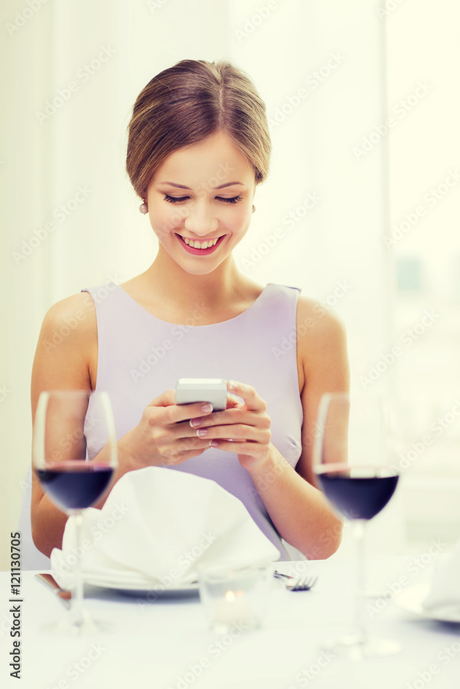 smiling woman with smartphone at resturant smiling woman with smartphone at resturant
