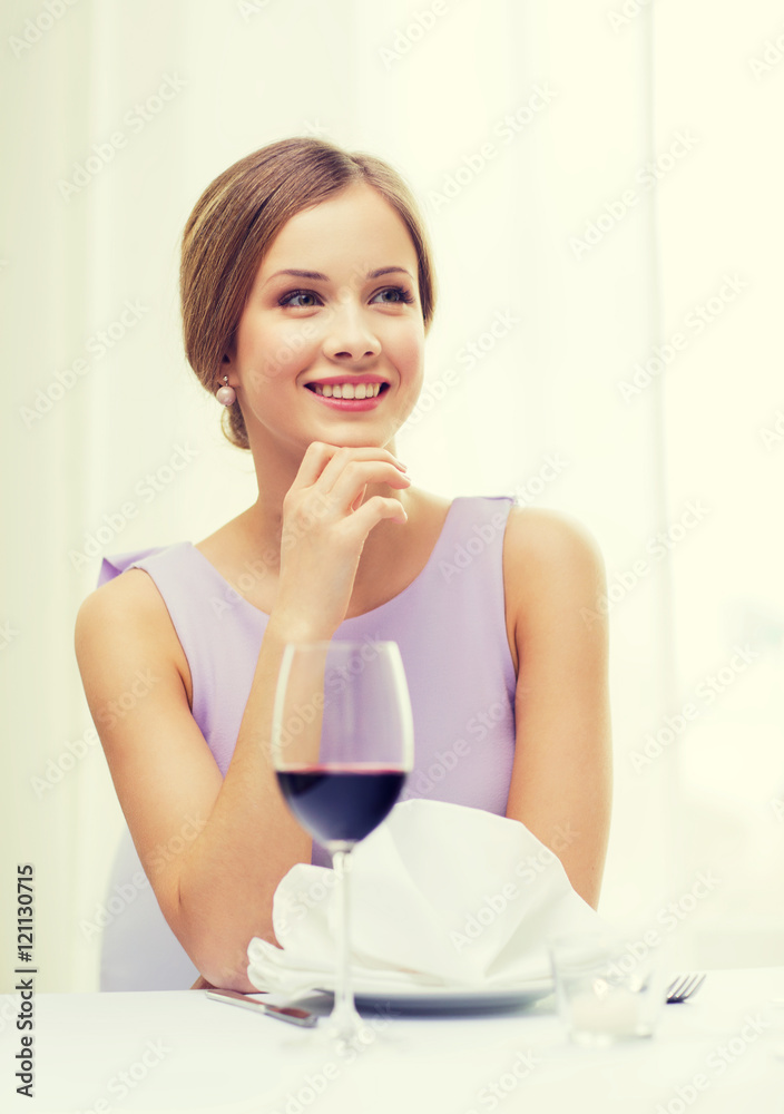 smiling woman with glass of whine waiting for date smiling woman with glass of whine waiting for date