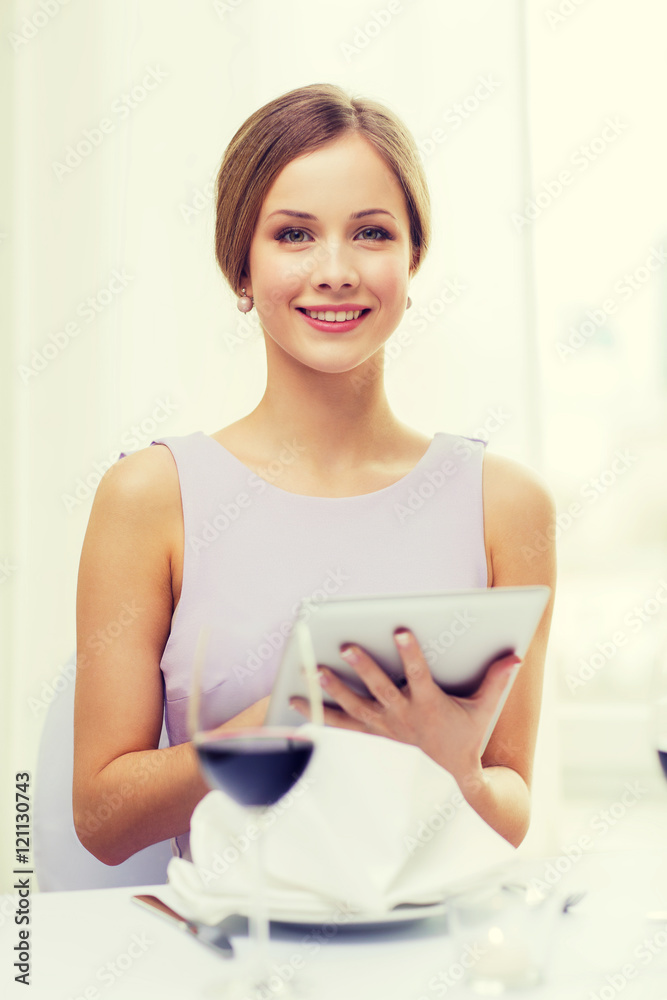 smiling woman with tablet pc computer at resturant smiling woman with tablet pc computer at resturant