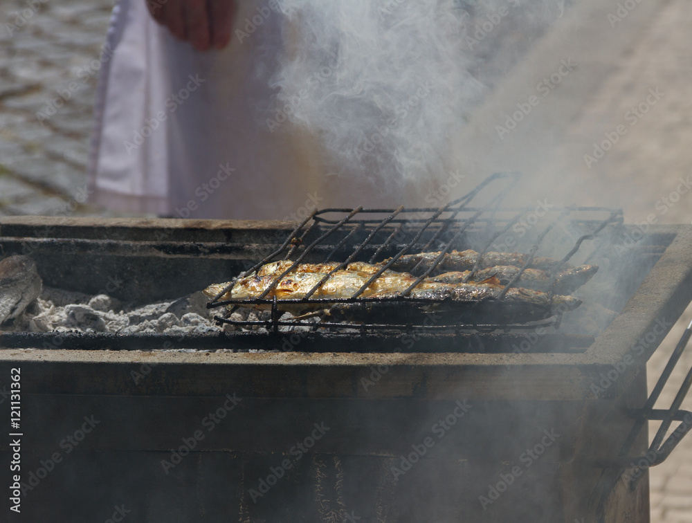 Fried fish on a hot coal.