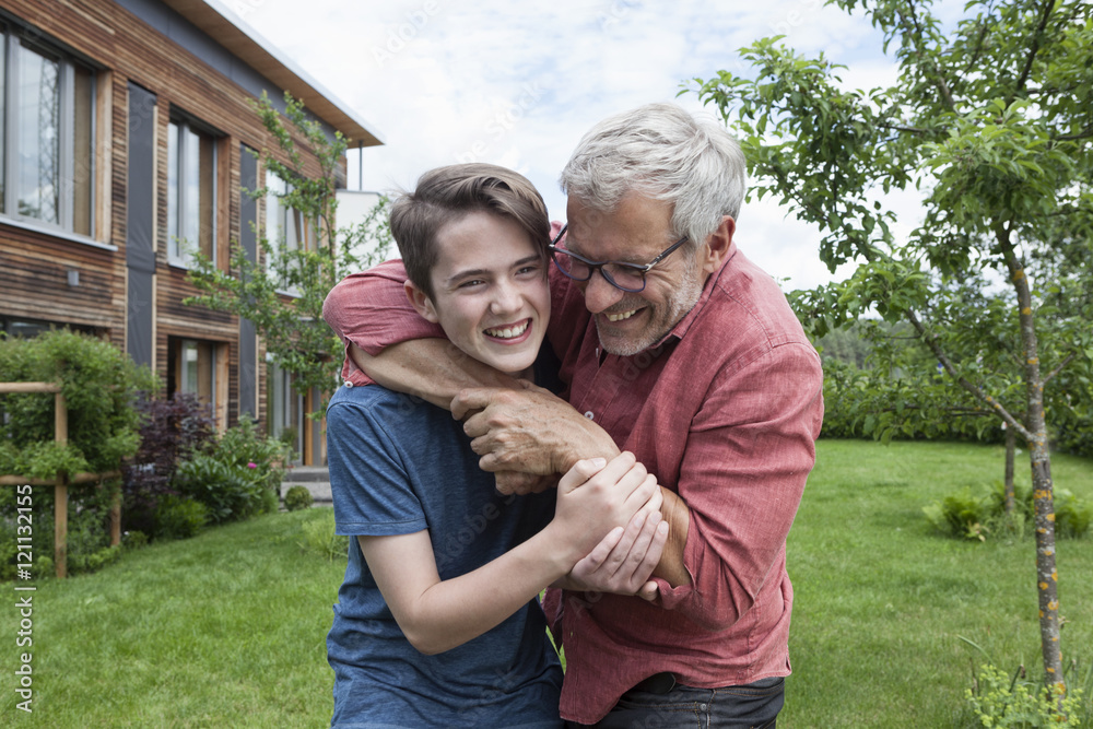 Playful father and son in garden Playful father and son in garden