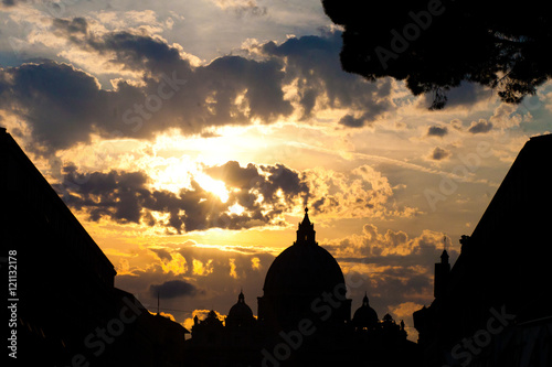 Silhouette of St. Peter's Basilic illuminated with golden sunshi
