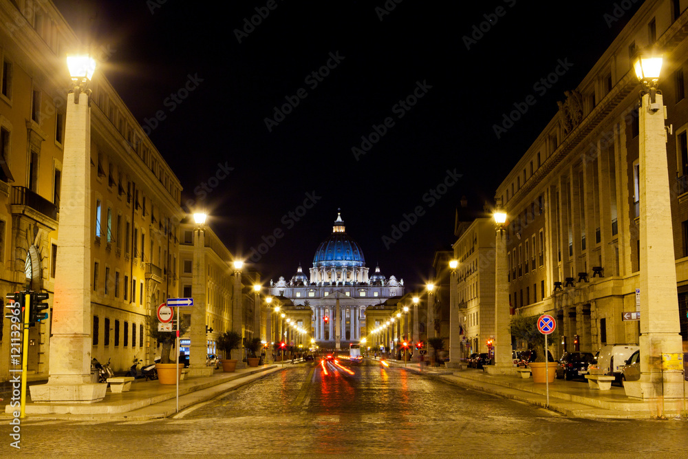 Long alley illuminated with street lights leads to St Peter's Ba