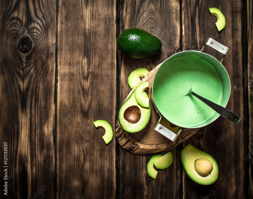 Fresh avocado sauce. On wooden background. Fresh avocado sauce. On wooden background.