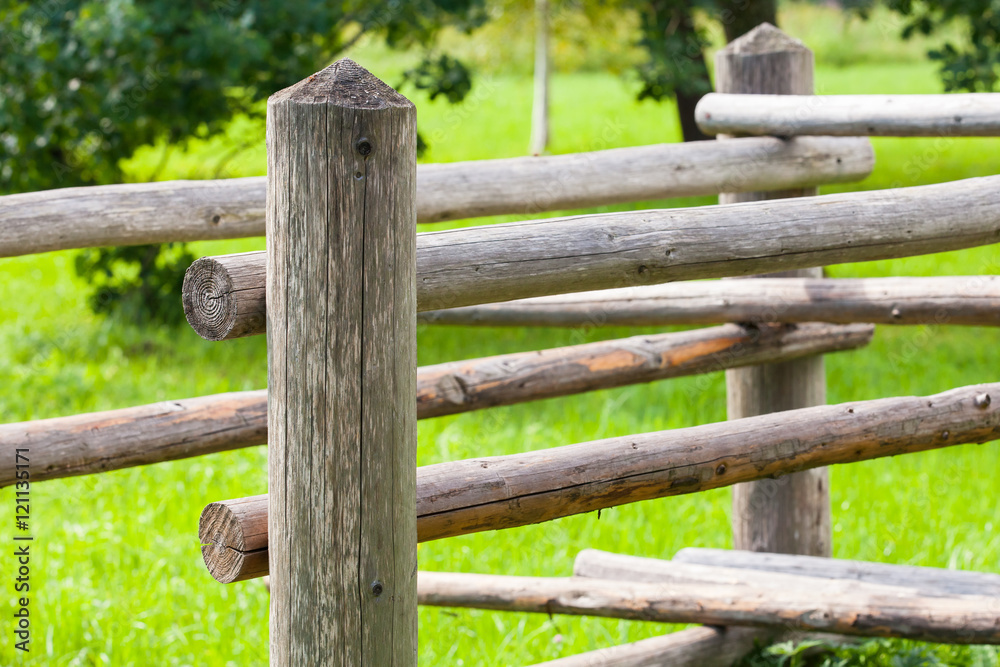 Wooden fence with green summer grass