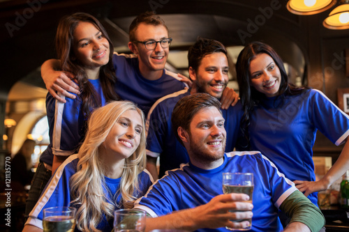 football fans or friends with beer at sport bar