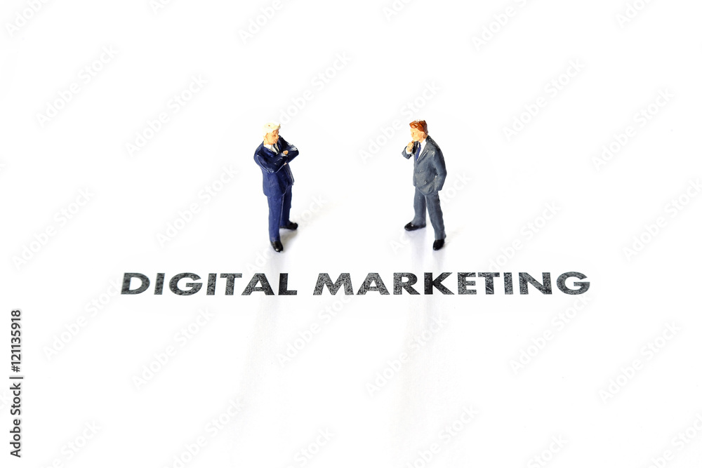 Miniature business man over digital marketing text
