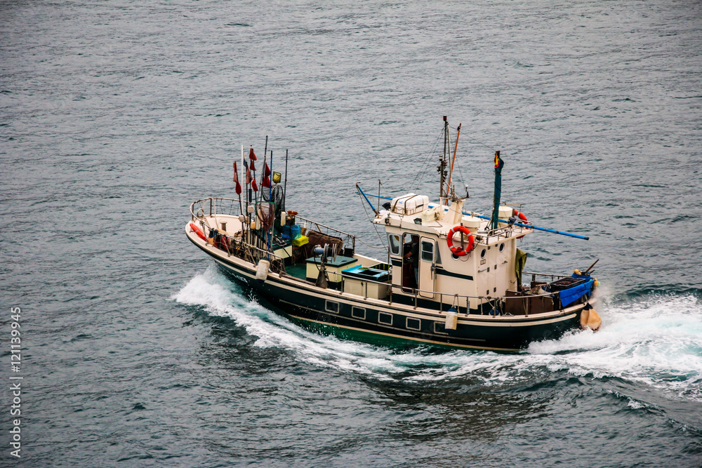 Fototapeta premium Fishing boat sailing in the atlantic Ocean. San Sebastian, Basque Country. Spain