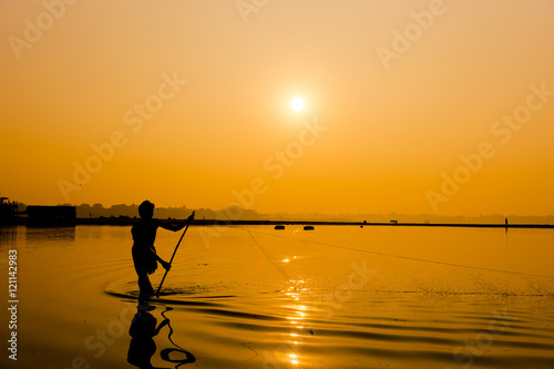 Silhouette Fisherman near U Bein bridge in Amarapura,Mandalay ,