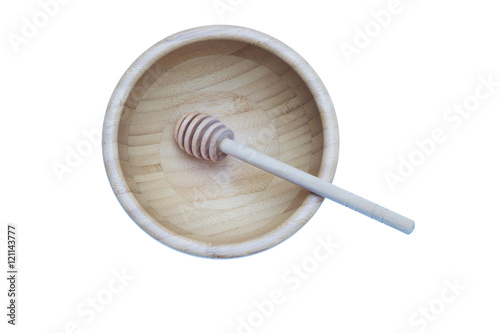 Honey stick in bamboo wooden bowl isolated