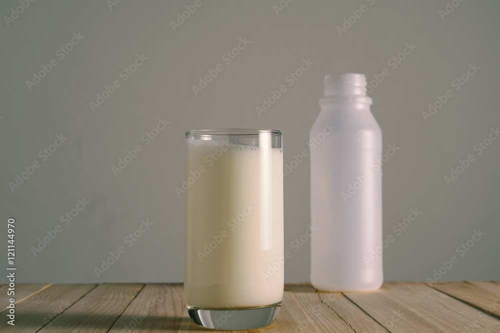 Glass of milk on a wooden floor Glass of milk on a wooden floor