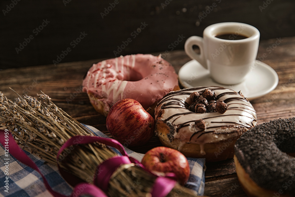 Donuts and coffee on wooden table