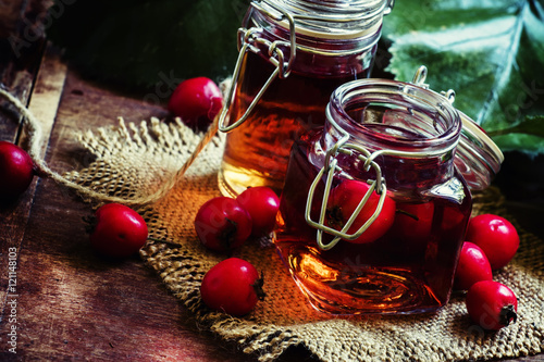 Obraz na plátně Alcohol tincture of hawthorn berries, vintage toned photo, selec