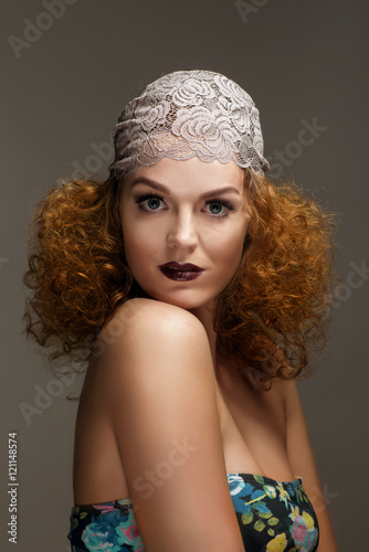 Old-fashioned red-haired woman with professional make up and hairstyle