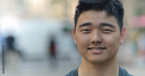 Young Asian man in city face portrait