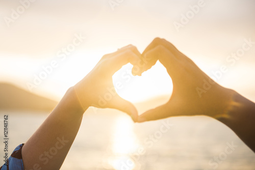 couple made heart symbol by hand